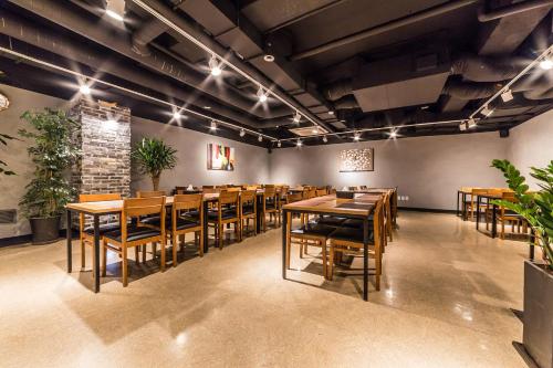 a dining room with wooden tables and chairs at WD Hotel in Seoul