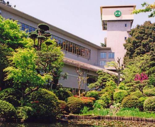 a building with a garden in front of it at Hachinohe Park Hotel in Hachinohe