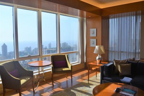 a living room with a large group of windows at Four Seasons Hotel Mumbai in Mumbai