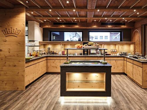 a large kitchen with wooden walls and wooden floors at Hotel "Krone" - Immenstadt-Stein in Immenstadt im Allgäu