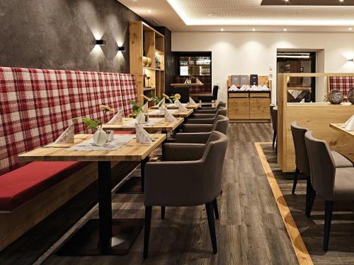 a dining room with a long table and chairs at Hotel Die Krone - Immenstadt-Stein in Immenstadt im Allgäu