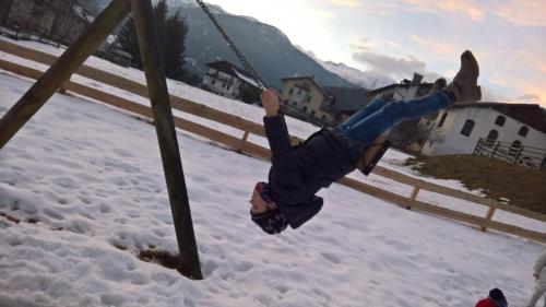 a person on a swing in the snow at Hotel Serenella in Canale San Bovo