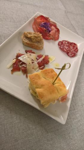 a white plate with food on a table at Hotel Serenella in Canale San Bovo