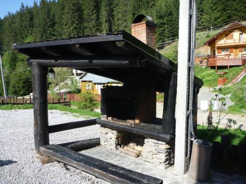a small brick oven in front of a house at Coliba Drumetului in Vatra Dornei