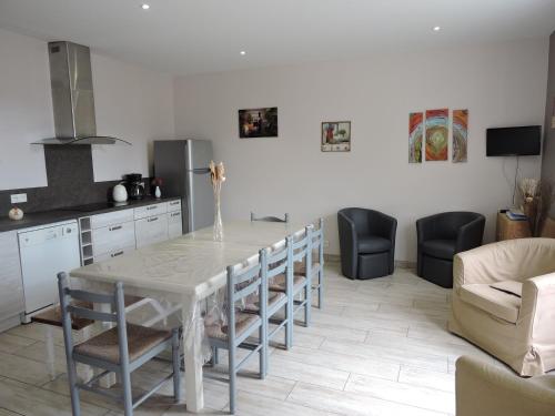 une cuisine et une salle à manger avec une table et des chaises dans l'établissement Orée des Prairies, à Mareuil-sur-Cher