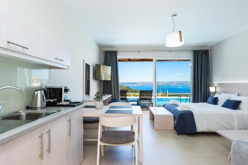 a kitchen and living room with a bed and a sink at Sun and Sea Plus Resort in Plaka