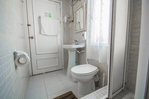 La petite salle de bains est pourvue de toilettes et d'un lavabo. dans l'établissement Nuevo Suizo, à Séville