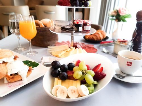 a table with a plate of food and a bowl of fruit at Art Hotel Kalelarga in Zadar