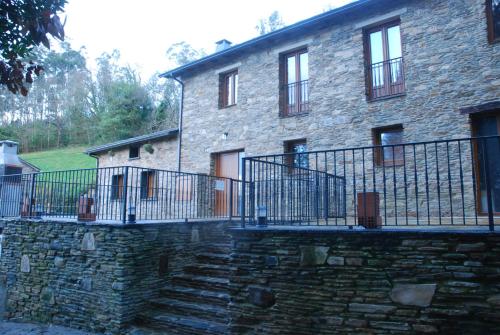 a stone house with a stone staircase in front of it at Isabel Artemis ES in San Tirso de Abres