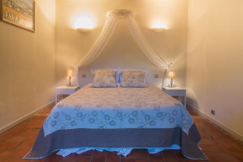 a bedroom with a bed with a canopy at Domaine Jobert in Aubagne