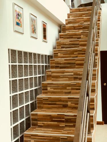 a wooden staircase in a house with a wall of glass at Chiang Khan Riverside Pool Villa in Chiang Khan
