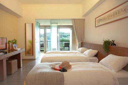 Letto o letti in una camera di Luminous Hot Spring Resort & SPA