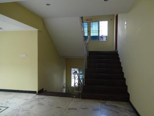 an empty room with a staircase in a building at Hotel Susee Park in Tiruchchirāppalli