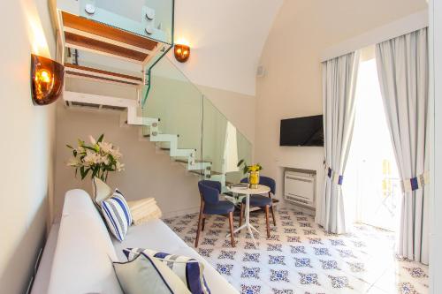 a living room with a staircase and a table at DieciSedici in Amalfi