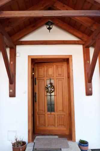 a front door of a house with a wooden ceiling at Penzion v Podhradí in Štramberk