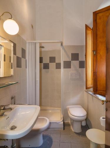 a bathroom with a sink and a toilet and a shower at Helvetia Pisa Tower in Pisa