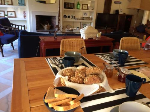 a table with a tray of donuts on it at Lisbon Surf Villa in Costa da Caparica