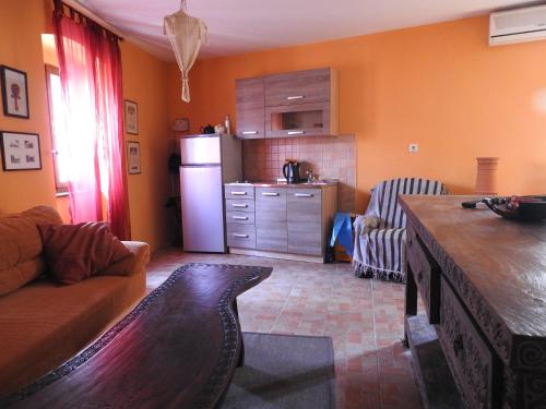 a living room with a couch and a kitchen at Blue Bench Krk in Krk