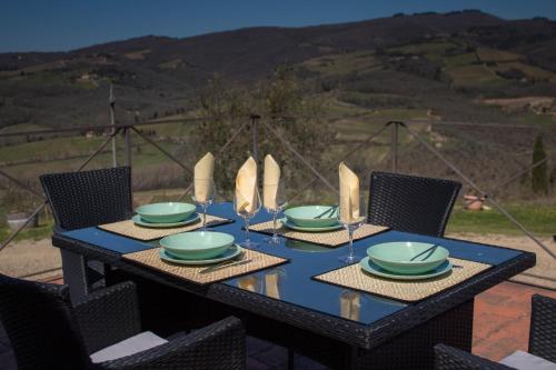 a black table with green plates and napkins on it at Tenuta il Poggetto in Radda in Chianti