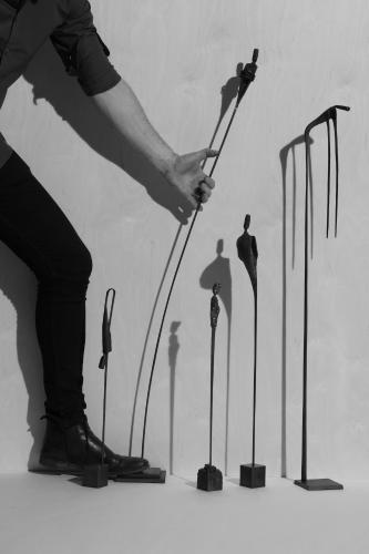 a person holding a hammer in front of a group of swords at ONNO Boutique Hotel & Apartments in Rendsburg