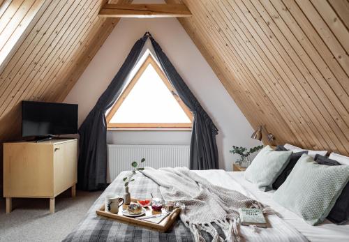 a bedroom with a bed and a large window at Willa Malinowa in Zakopane