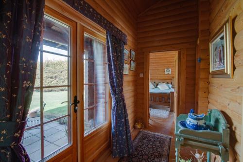 a room with a window in a log cabin at Balnabrechan Lodge in Arbroath