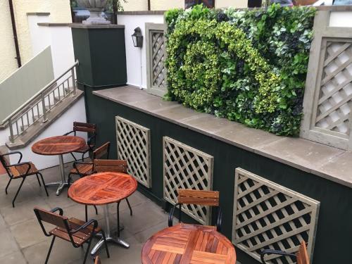 a group of tables and chairs on a patio at The Seaton Lane Inn - The Inn Collection Group in Seaham