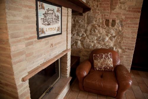 a leather chair sitting in front of a fireplace at Agriturismo San Fedele in Perugia