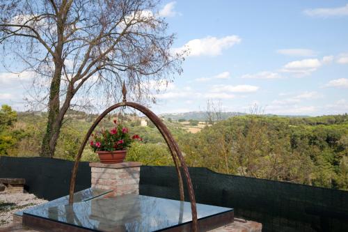 a fountain with a flower pot on top of a fence at Agriturismo San Fedele in Perugia