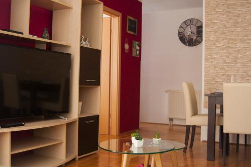 a living room with a flat screen tv and a table at Zen Voyage in Zagreb