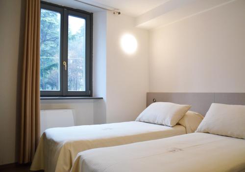 Posteľ alebo postele v izbe v ubytovaní Hotel Il Loggiato Dei Serviti
