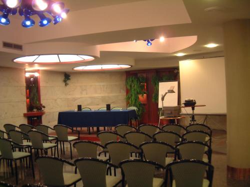 a room with a bunch of chairs and a table at Addaura Village e Congressi in Mondello