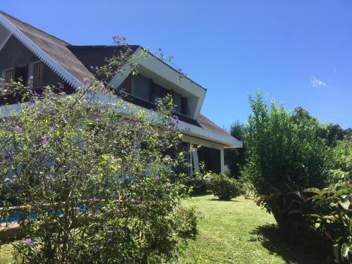 a house with a garden and some bushes at Caloupilé in Le Tampon