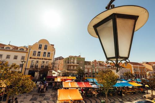 a city street with a street light and a market at Bordallo's Prime Apartments in Caldas da Rainha