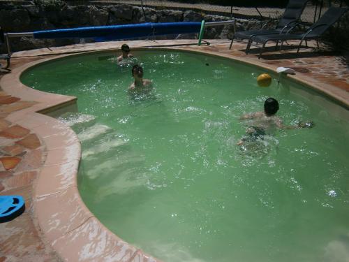 a group of people swimming in a swimming pool at La Gravelière in Rémuzat