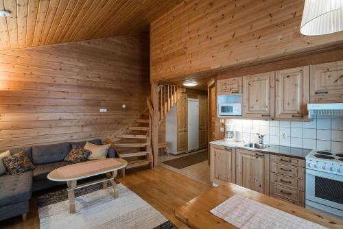 a kitchen and living room in a log cabin at Tundrea Holiday Resort in Kilpisjärvi