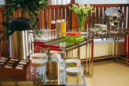 a restaurant with a table with plates and glasses at Mövenpick Hotel & Residences Nairobi in Nairobi