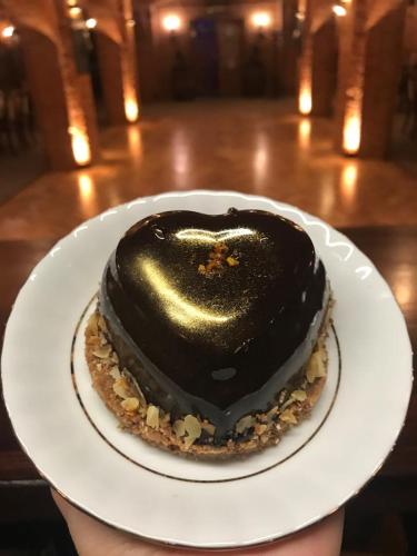 a chocolate covered dessert on a white plate at Karczma Rycerska Lebork in Lębork