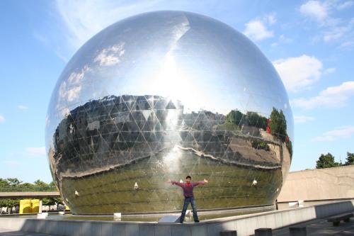 a man standing in front of a large ball at Hôtel Tilde in Paris