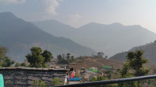 a village on a hill with mountains in the background at Hotel Mountain View in Sari