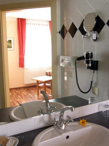 a bathroom with a sink and a mirror at Gasthof Safenhof in Bad Waltersdorf