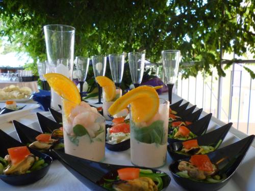 a table topped with plates of food and glasses of drinks at Hotel Europa in Grado