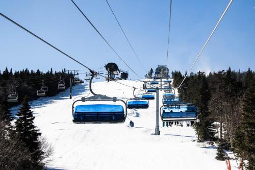 a ski lift going up a snow covered ski slope at Mountain Retreat in Wilmington