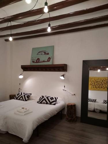 a bedroom with a bed and a mirror and a mirror at Pension Casa Pinilla in Cascante