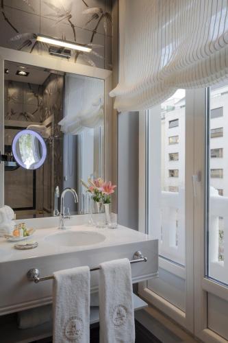a bathroom with a sink and a mirror at Relais & Châteaux Heritage Hotel in Madrid