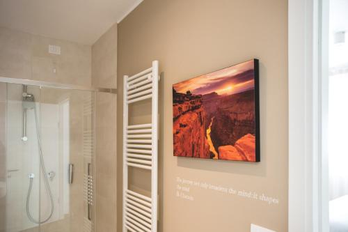 a painting hanging on a wall in a bathroom at Lullaby B&B in Treviso