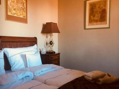 a bedroom with a bed and a lamp on a night stand at Leniwka in Świebodzin