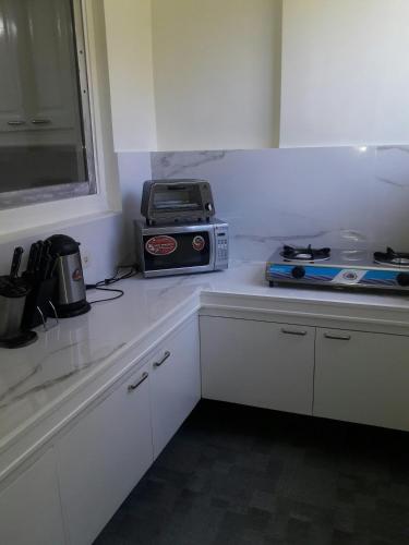 a kitchen counter with a toaster and a toaster oven on it at Golden Queen Suites in Baguio