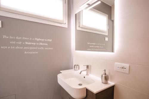 a bathroom with a sink and a mirror at Lullaby B&B in Treviso