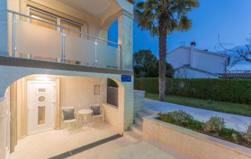 a house with a patio with a table and chairs at Villa Stephany in Poreč